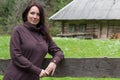 Beautiful woman near the fence in the village Royalty Free Stock Photo