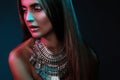 Beautiful woman in a necklace. Model in jewelry from silver. Beautiful indian jewellery. Bright lights Royalty Free Stock Photo