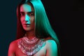 Beautiful woman in a necklace. Model in jewelry from silver. Beautiful indian jewellery. Bright lights Royalty Free Stock Photo