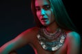 Beautiful woman in a necklace. Model in jewelry from silver. Beautiful indian jewellery. Bright lights Royalty Free Stock Photo