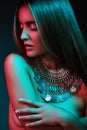 Beautiful woman in a necklace. Model in jewelry from silver. Beautiful indian jewellery. Bright lights