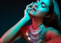 Beautiful woman in a necklace. Model in jewelry from silver. Beautiful indian jewellery. Bright lights Royalty Free Stock Photo