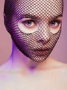 Beautiful Woman in Net on her Face lighted in pink