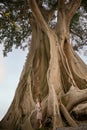 Beautiful woman next to giant ancient Cotton tree Royalty Free Stock Photo