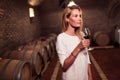 Beautiful woman oenologist tasting wine Royalty Free Stock Photo