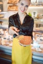 Beautiful woman offering cheese on delicatessen counter Royalty Free Stock Photo