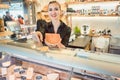 Beautiful woman offering cheese on delicatessen counter Royalty Free Stock Photo