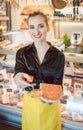 Beautiful woman offering cheese on delicatessen counter Royalty Free Stock Photo