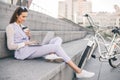 Beautiful woman office worker sitting on the steps and working on a laptop Royalty Free Stock Photo