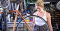 Woman oiling bicycle at workshop 4k