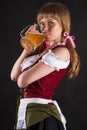 Beautiful woman Oktoberfest drinks beer