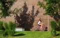 Beautiful woman with old bike in front of a brick wall Royalty Free Stock Photo