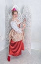Beautiful woman in old-fashioned medieval dress holding rose