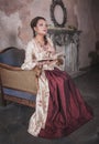 Beautiful woman in old historic medieval dress with book Royalty Free Stock Photo