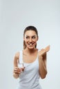 Beautiful Woman Opened Mouth Holding Vitamin Pill In White Teeth. Smiling Girl Holding Capsule With Omega-3 Between Teeth. Royalty Free Stock Photo