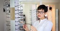 Beautiful woman with optician trying eyeglasses Royalty Free Stock Photo