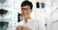 Beautiful woman with optician trying eyeglasses