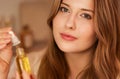 Beautiful woman with organic oil serum bottle, evening beauty and skincare routine