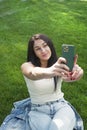 Beautiful woman outdoor young woman resting in city park and take a selfie photo Royalty Free Stock Photo