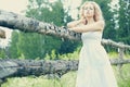 Beautiful woman outdoors enjoying nature in dress at summer mead