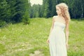 Beautiful woman outdoors enjoying nature in dress at summer mead Royalty Free Stock Photo