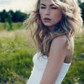 Beautiful woman outdoors enjoying nature in dress at summer mead Royalty Free Stock Photo