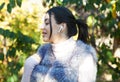 Beautiful woman outdoors, has a wireless earphones in her ears Royalty Free Stock Photo