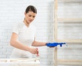 Beautiful woman painting old furniture with white color Royalty Free Stock Photo