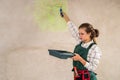 Beautiful woman painting walls with tray and roller Royalty Free Stock Photo