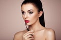 Beautiful woman paints lips with lipstick Royalty Free Stock Photo