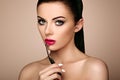 Beautiful woman paints lips with lipstick Royalty Free Stock Photo