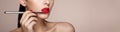 Beautiful woman paints lips with lipstick Royalty Free Stock Photo