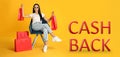 Beautiful woman with paper shopping bags in armchair and words Cash Back on yellow background. Banner design Royalty Free Stock Photo