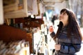 Beautiful woman in Paris selecting a book Royalty Free Stock Photo