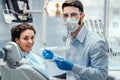 Beautiful woman patient having dental treatment at dentist`s office. Woman visiting her dentist Royalty Free Stock Photo