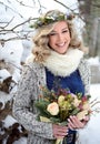 Beautiful woman with perfect candid smile holds a bouquet of roses and fir branches. Happy sincere winter outdoor portrait Royalty Free Stock Photo