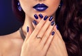 Beautiful woman with perfect make-up and blue manicure wearing jewellery Royalty Free Stock Photo