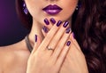 Beautiful woman with perfect make-up and purple manicure wearing jewellery Royalty Free Stock Photo