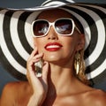 Beautiful woman with perfect skin in hat and sunglasses - close up portrait Royalty Free Stock Photo