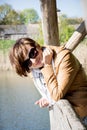 Beautiful woman on a pier at the lake