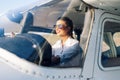 Woman Pilot Sitting in Cabin of Modern Aircraft.