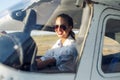 Woman Pilot Sitting in Cabin of Modern Aircraft.