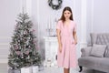 Beautiful woman in pink dress and with beautiful Christmas decorations o background Royalty Free Stock Photo