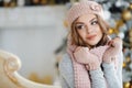 Beautiful woman in pink hat near Christmas tree Royalty Free Stock Photo