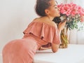 Beautiful woman with pink peonies