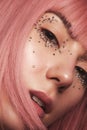 Beautiful woman in a pink wig and creative makeup with rhinestones. Beauty face.