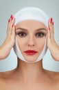 Beautiful woman after plastic surgery with bandaged face. Beauty, Fashion and Plastic Surgery concept Royalty Free Stock Photo