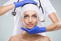 Beautiful woman with plastic surgery, depiction, plastic surgeon hands Royalty Free Stock Photo