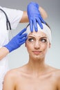 Beautiful woman with plastic surgery, drawn, plastic surgeon hands Royalty Free Stock Photo