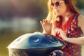 beautiful woman playing with hangdrum in nature. Royalty Free Stock Photo